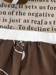 Brown baby pants with football print and text detail on top.