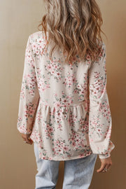 Floral print peplum blouse with square neck and long sleeves.