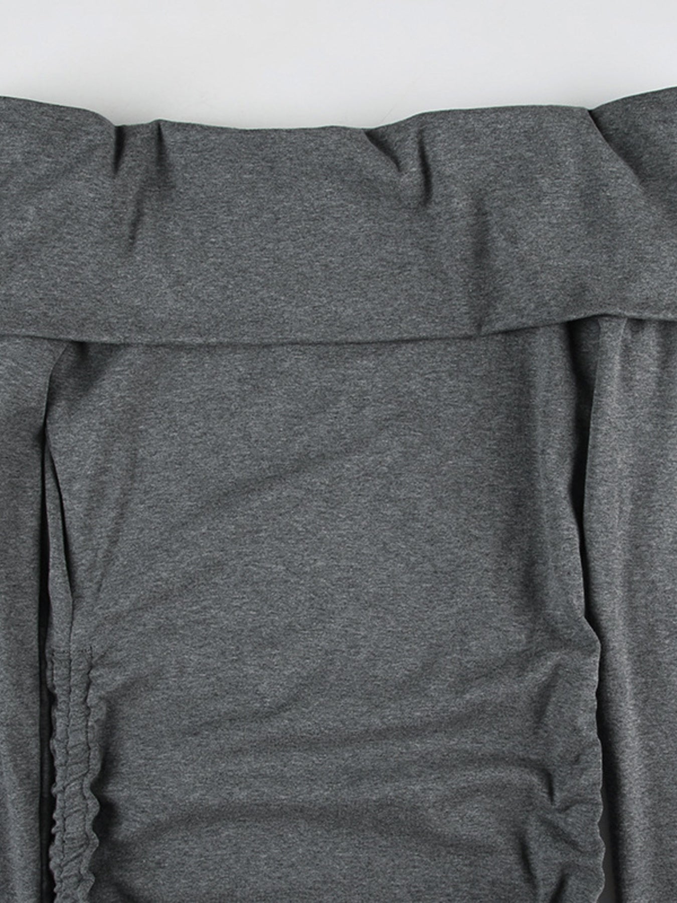 Grey ruched bodycon mini dress with drawstring detail and off-shoulder neckline.