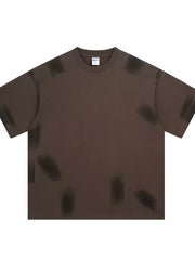 Brown t-shirt with abstract brushstroke pattern, crew neck, and short sleeves.