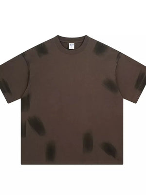 Brown t-shirt with abstract brushstroke pattern, crew neck, and short sleeves.