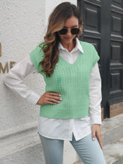 Light Green cable knit V-neck sleeveless sweater vest over a white collared shirt.