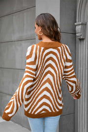 Caramel zebra stripe knit sweater with voluminous sleeves and a crew neck.