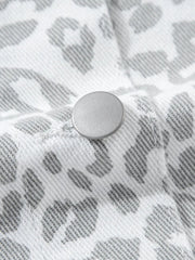 White denim jacket with stone-washed leopard print and button detail.