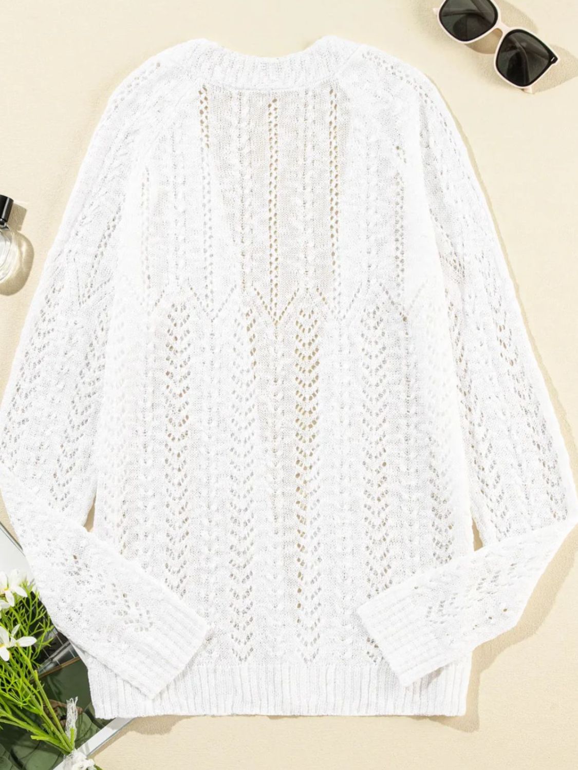 White openwork chevron knit cardigan with long sleeves and a V-neck.