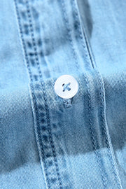 Light blue denim shirt dress with button detail and ruffled yoke.