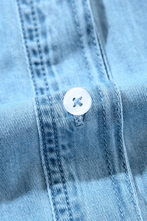 Light blue denim shirt dress with button detail and ruffled yoke.