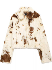 Cropped faux fur jacket with brown cow print pattern and zip-up front.