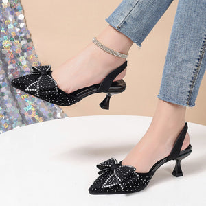 Black slingback heels with rhinestone bowknot detail and kitten heel.