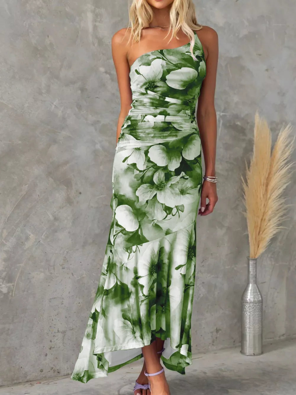 Olive green floral one-shoulder maxi dress with ruched bodice and asymmetrical hem.