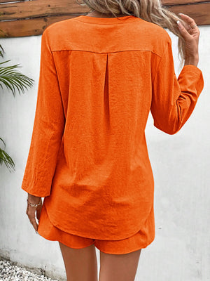 Orange linen henley shirt with back pleat detail and drawstring shorts.