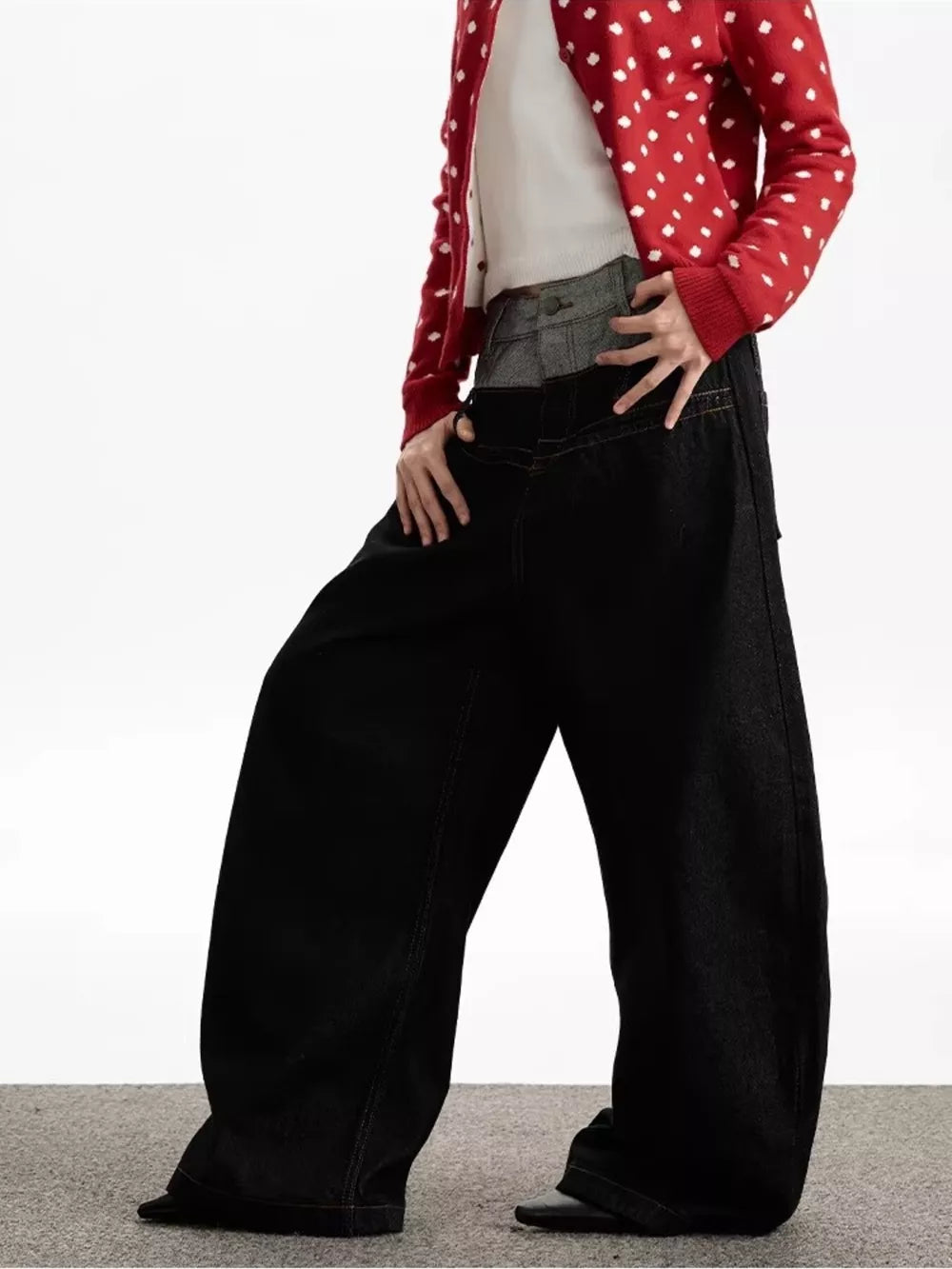 Layered double waist wide leg jeans in dark wash cotton, styled with a red polka dot cardigan.