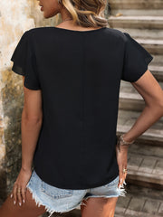 Black asymmetric button-down blouse with flutter sleeves and a casual cut.