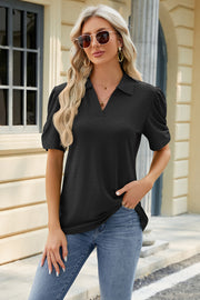 Black perforated polo top with puff sleeves and a V-neck collar.