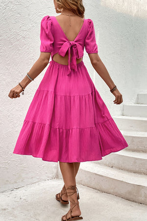 Hot pink tiered midi dress with puff sleeves and back tie detail