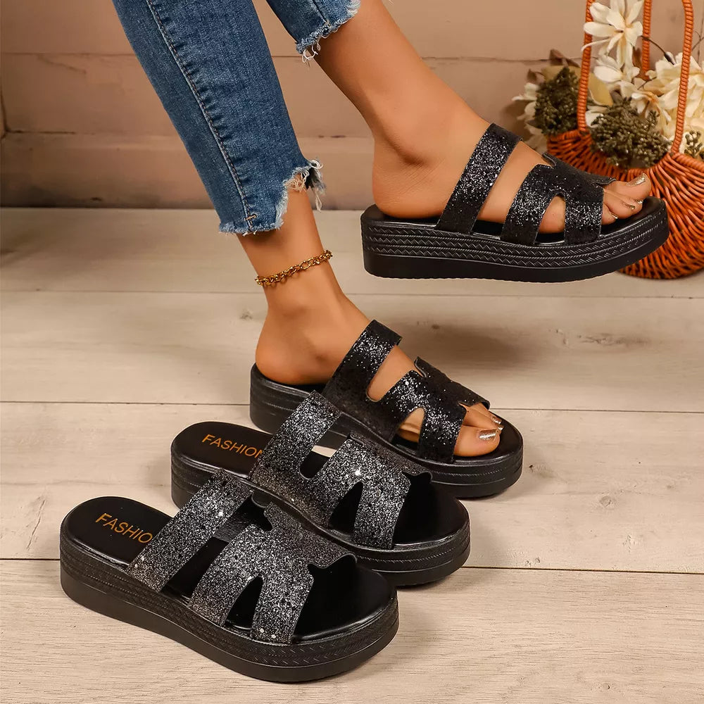 Black glitter platform sandals with open toe and double strap detail.