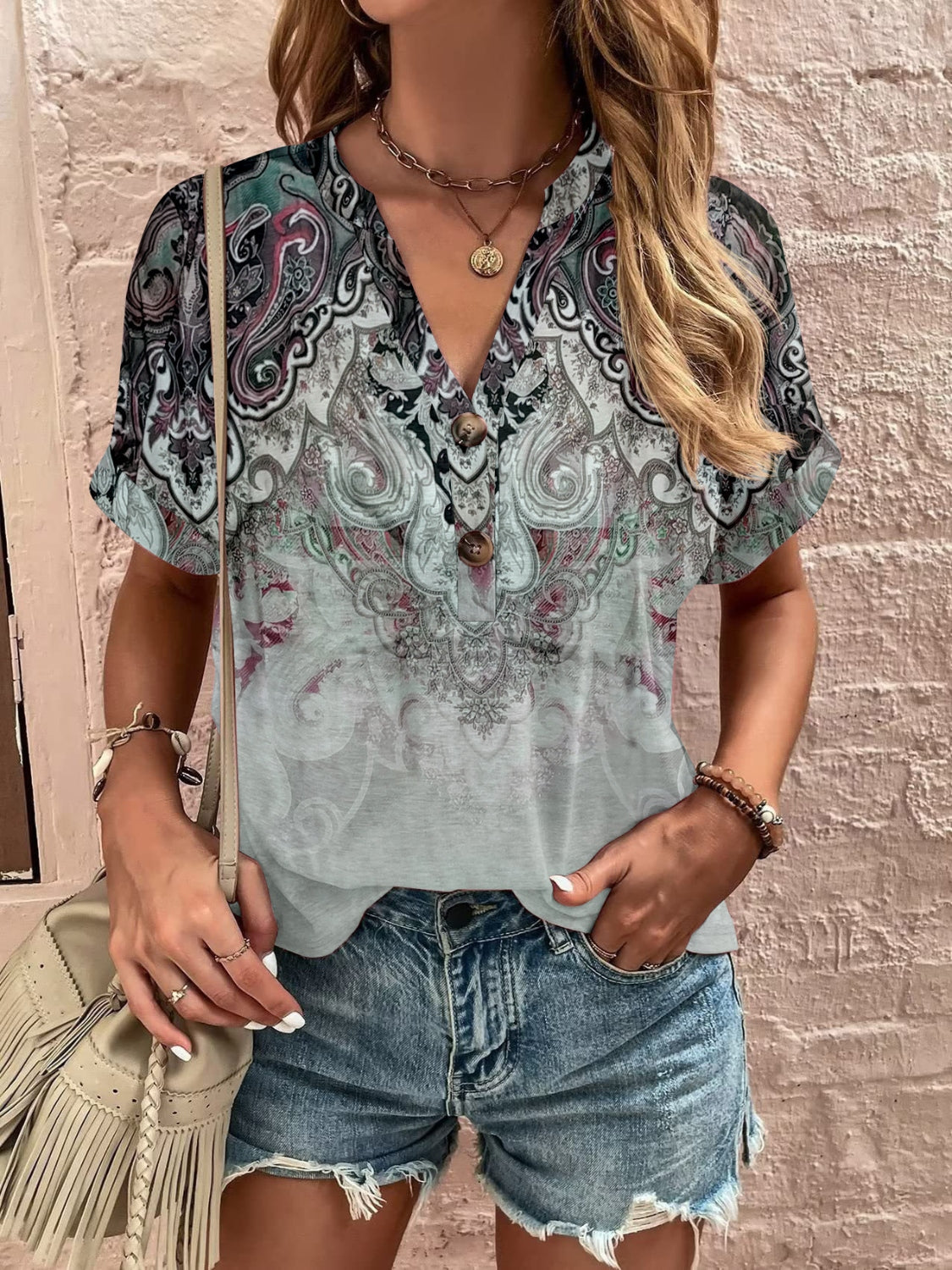 Bohemian tapestry henley blouse with paisley print, V-neck, and button detail.