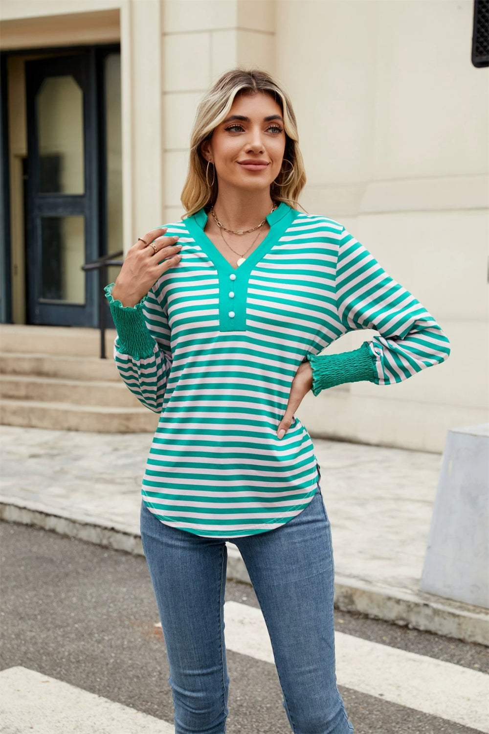 Striped long sleeve blouse in turquoise and white with button detail and smocked cuffs.