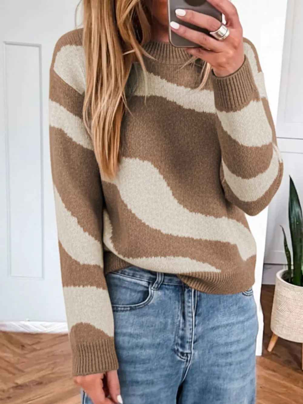 Cozy knit sweater with wavy camel and cream stripes, crew neck, long sleeves.