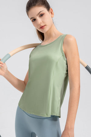 Light green performance tank top with curved back panel detail and round neckline.