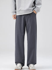 Oversized dark gray casual pants with a loose fit and cotton blend material.