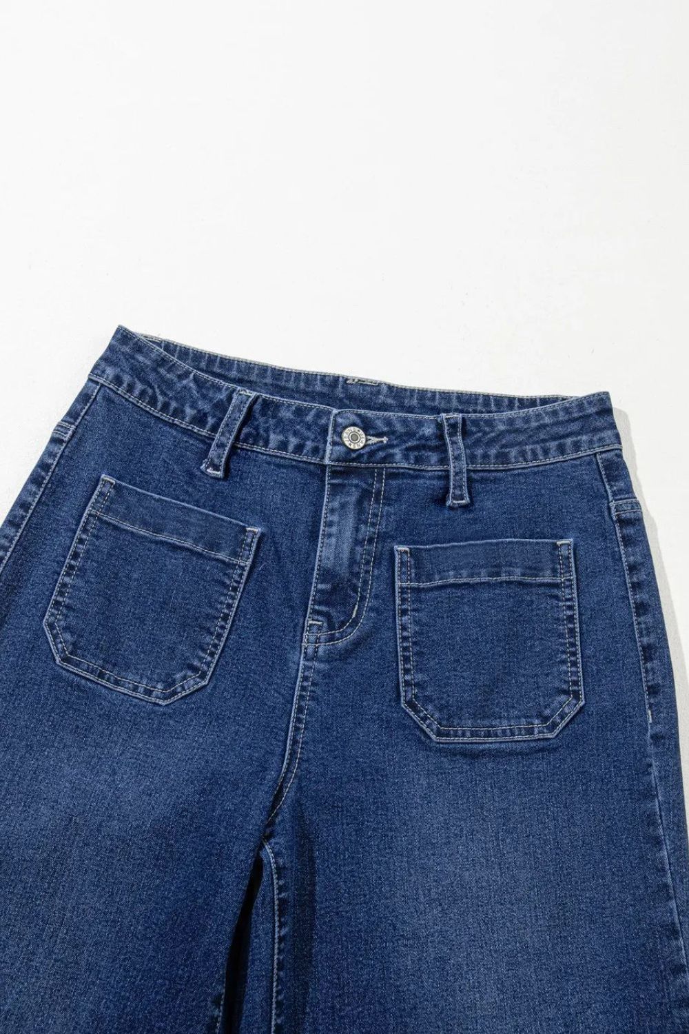 Utility pocket wide leg jeans in medium wash denim with a buttoned front and large front patch pockets.