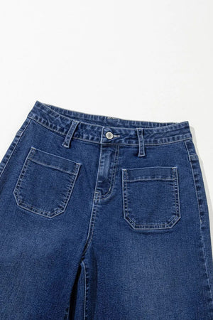 Utility pocket wide leg jeans in medium wash denim with a buttoned front and large front patch pockets.