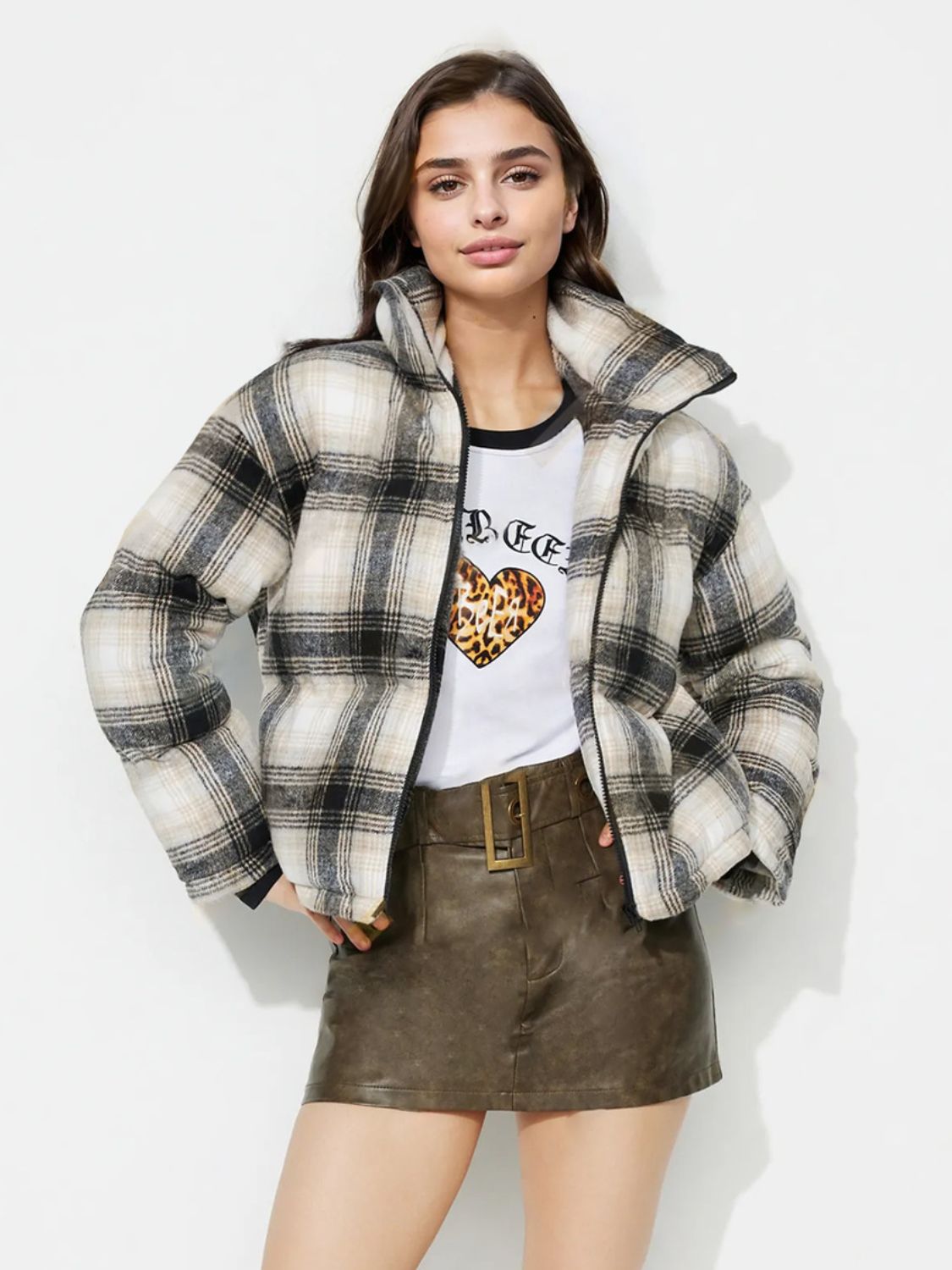 Plaid puffer jacket in gray with a high collar and zip closure.