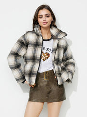 Plaid puffer jacket in gray with a high collar and zip closure.