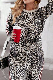 Leopard print tracksuit with red and white sporty side stripes on sleeves and pants.