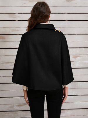 Black asymmetric cape jacket with gold button detail on shoulder