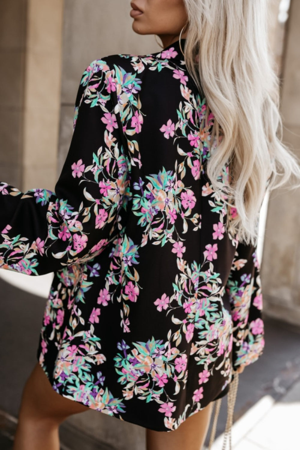 Black floral print wrap blazer with long sleeves and a notched collar.