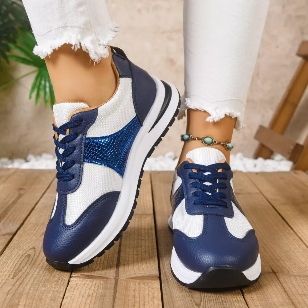 Blue and white lace-up sneakers with textured blue accents and white soles.