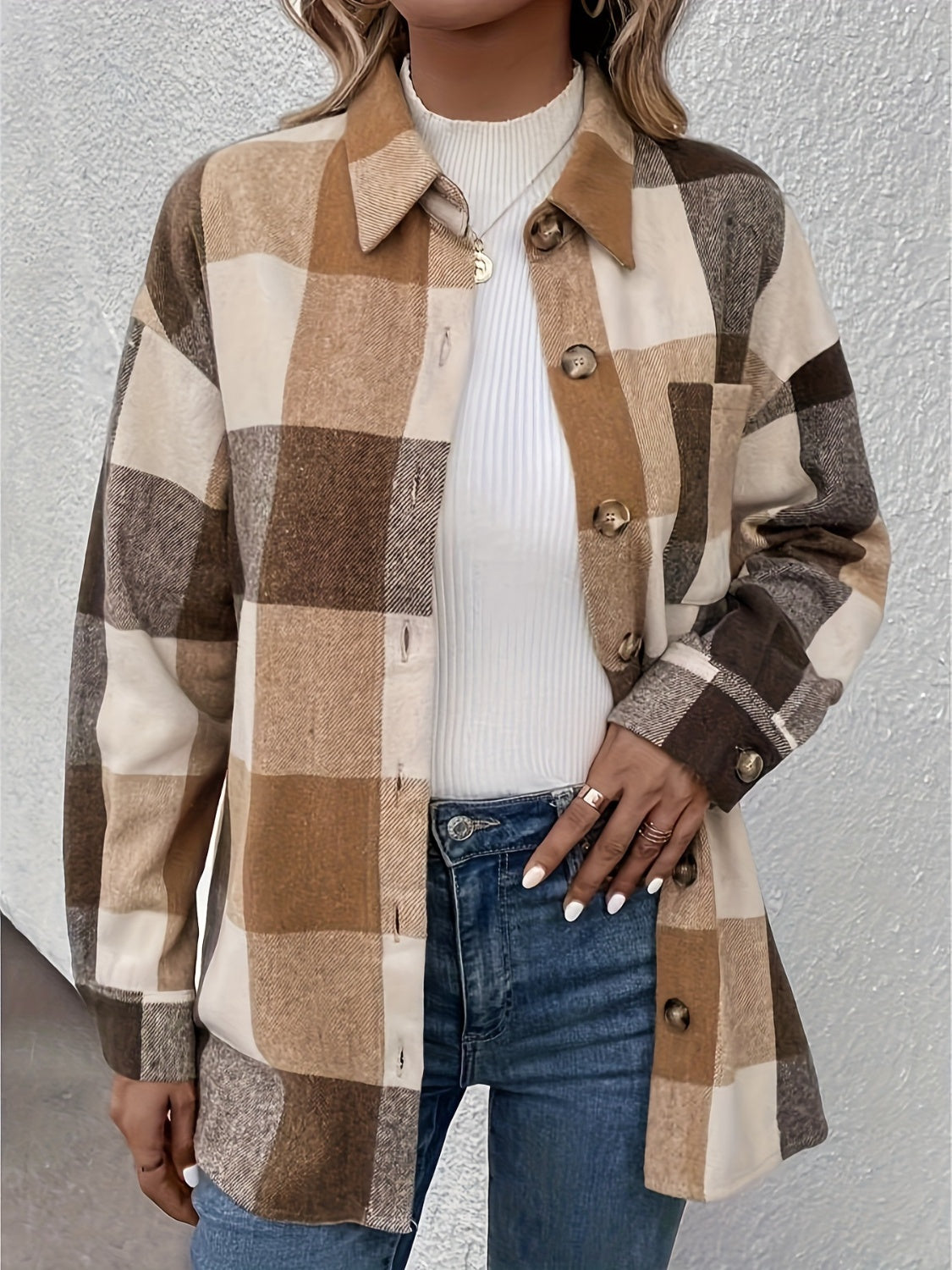 Oversized camel plaid shacket with button detail and collar, worn over a white turtleneck.