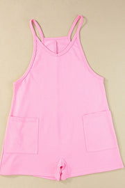 Pink spaghetti strap romper with patch pockets and V-neck.