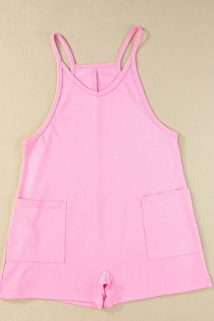 Pink spaghetti strap romper with patch pockets and V-neck.