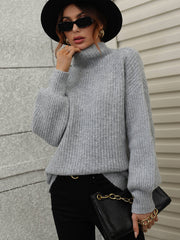 Gray ribbed knit turtleneck sweater with voluminous balloon sleeves.