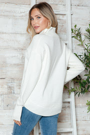 White ribbed knit funnel neck pullover sweater with long sleeves.