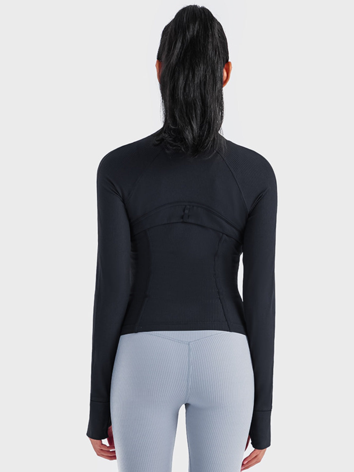 Black ribbed performance zip-up track jacket with thumbholes and contoured seams.