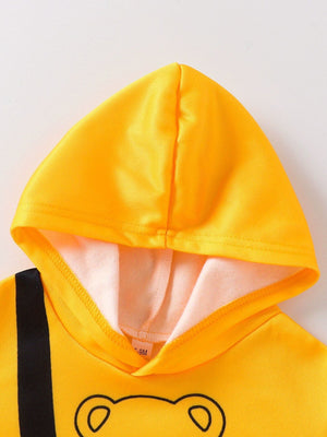 Yellow bear graphic hoodie with black stripe detail and soft lining.