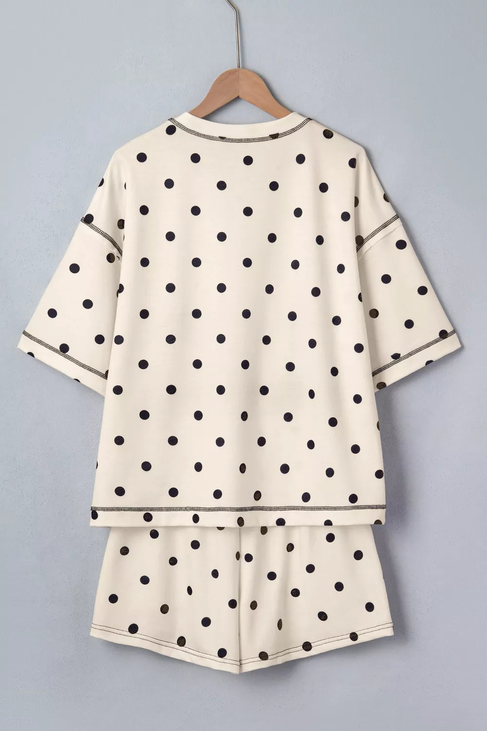 Cream polka dot two-piece set with drawstring shorts and short sleeve top.