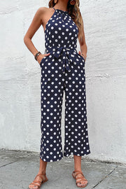 Navy polka dot halter neck palazzo jumpsuit with tie belt and pockets