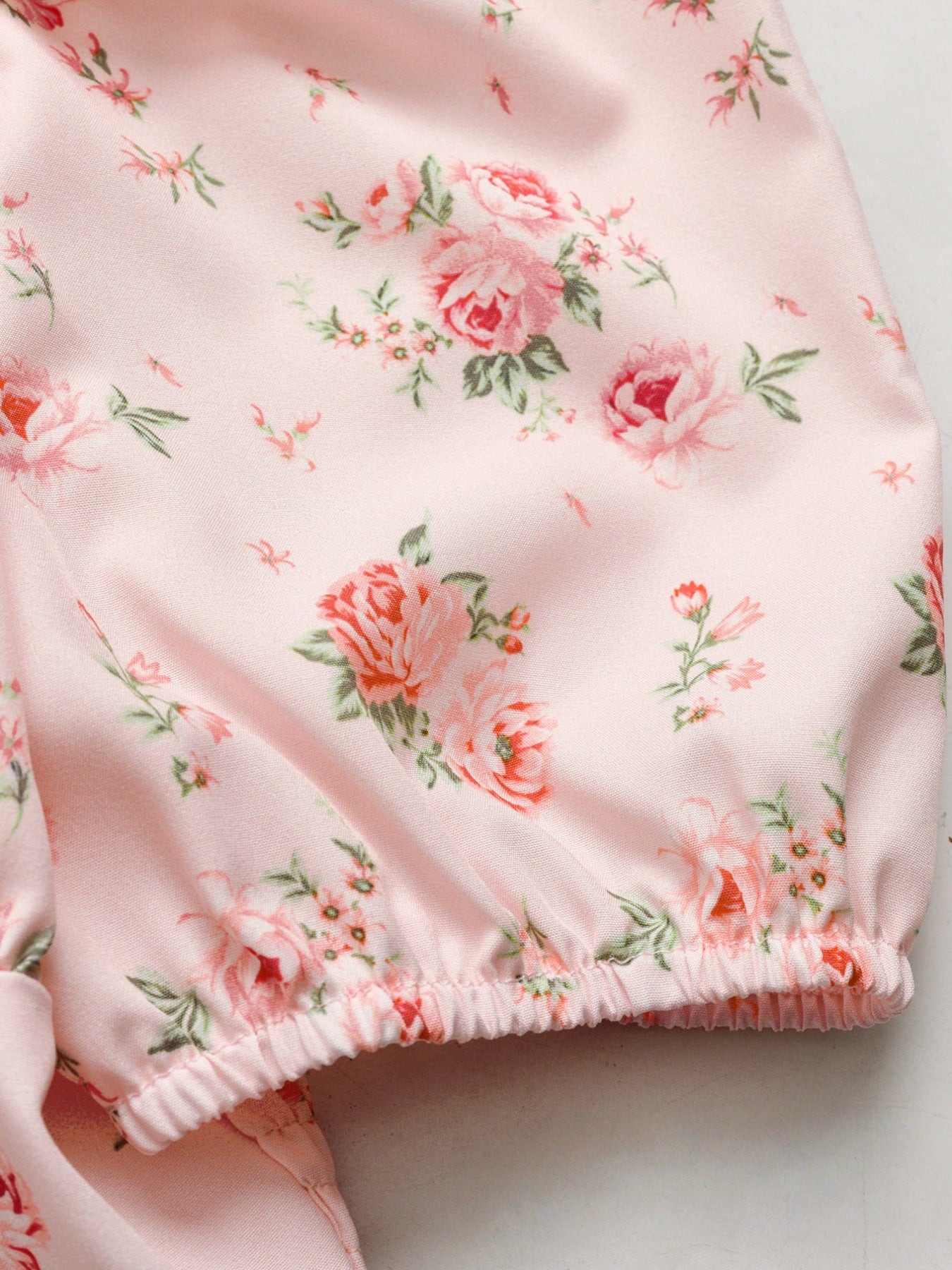 Pink floral tie front puff sleeve blouse with cinched hem