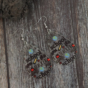 Transparent teardrop earrings with school-themed graphics like apples, pencils, and globes.