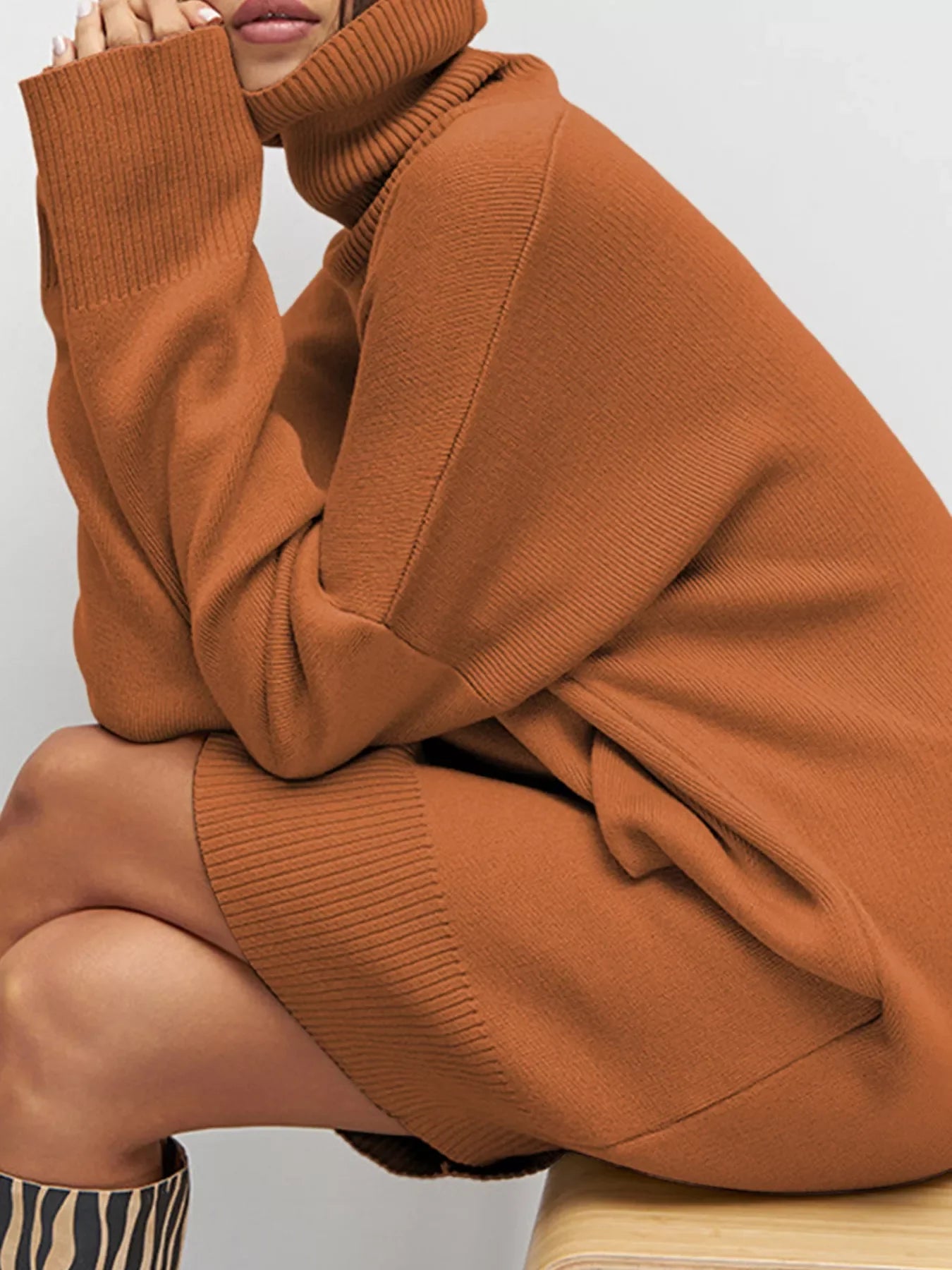 Caramel drop shoulder turtleneck sweater dress with ribbed cuffs and hem.