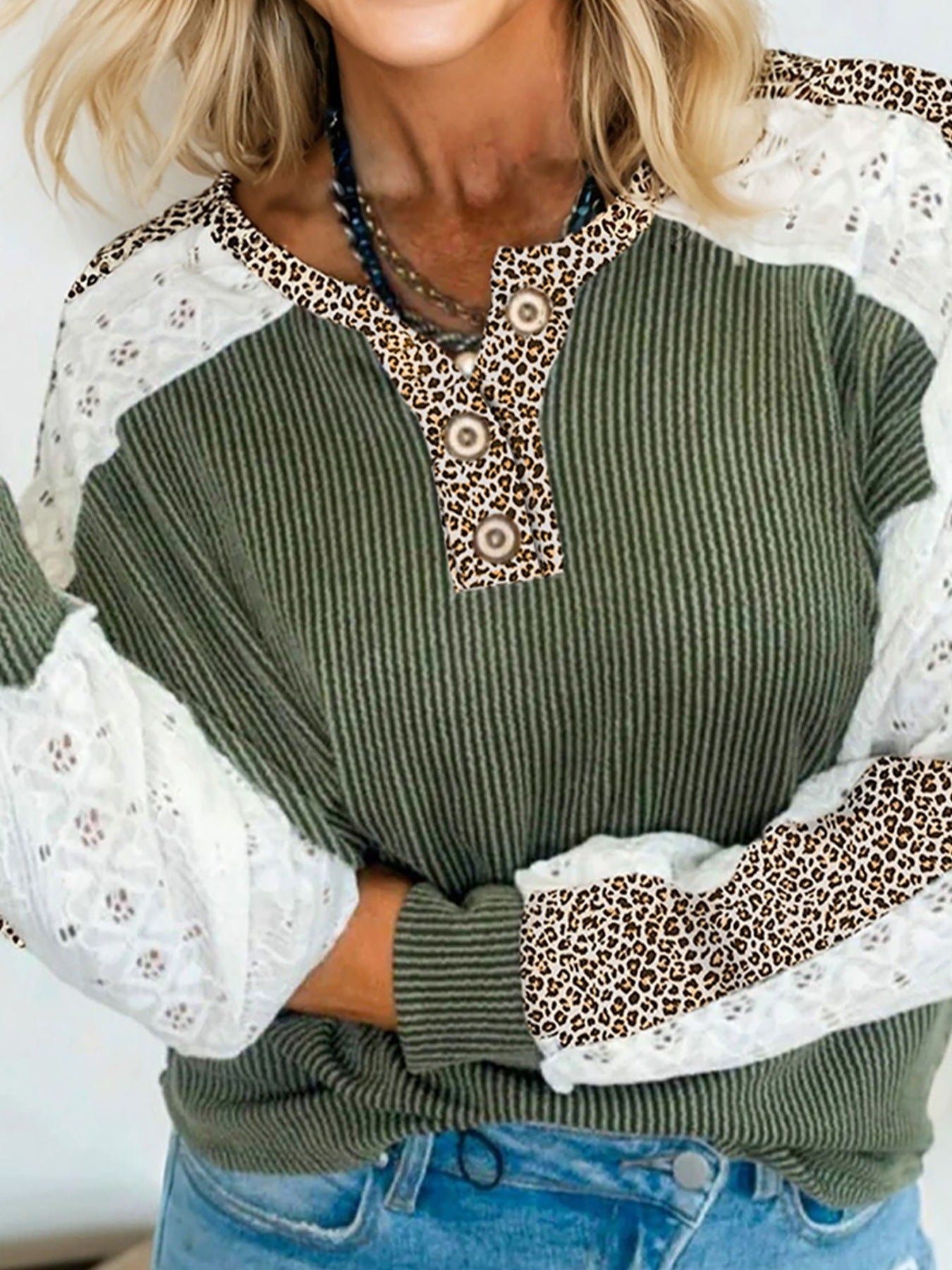 Waffle knit henley top in dark green with leopard print and lace sleeves.