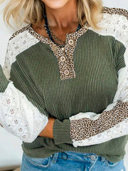Waffle knit henley top in dark green with leopard print and lace sleeves.