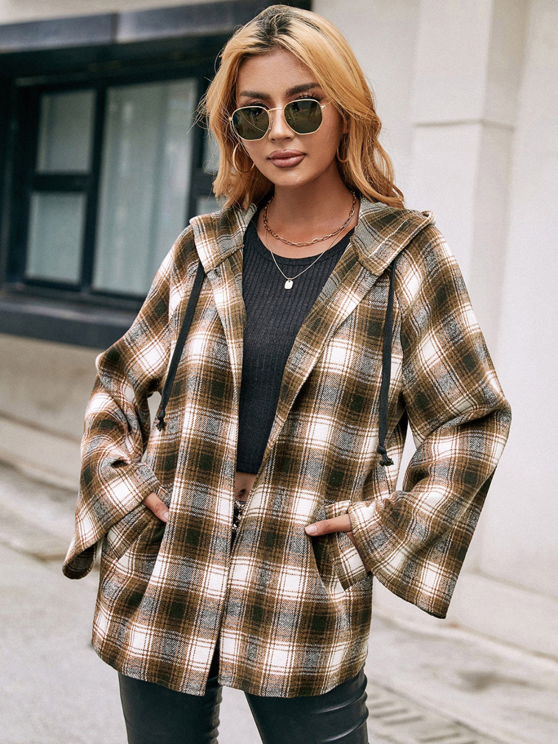 Flared sleeve hooded shacket in camel plaid with drawstring details and pockets.
