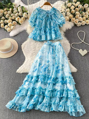 Sky blue floral ruffle set with bow detail, featuring a ruffled neckline and short sleeves.