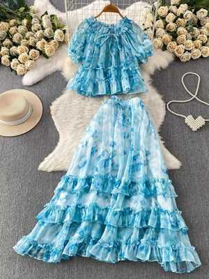 Sky blue floral ruffle set with bow detail, featuring a ruffled neckline and short sleeves.